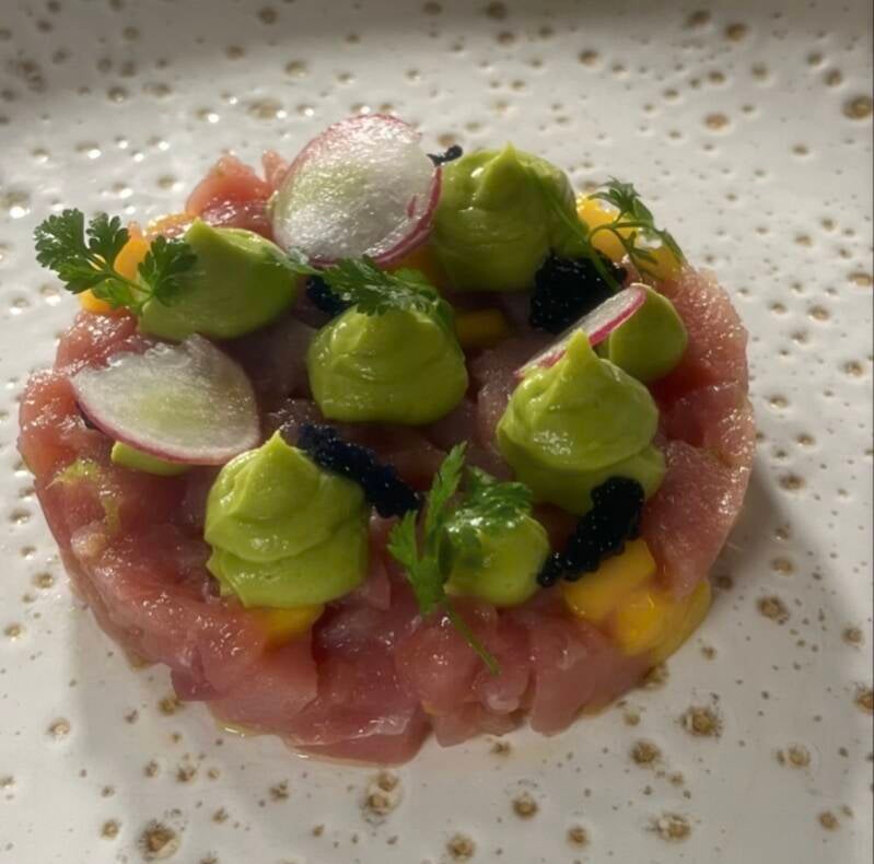Fresh tuna tartare with citrus dressing and microgreens, a light and elegant starter for summer villa dinners.