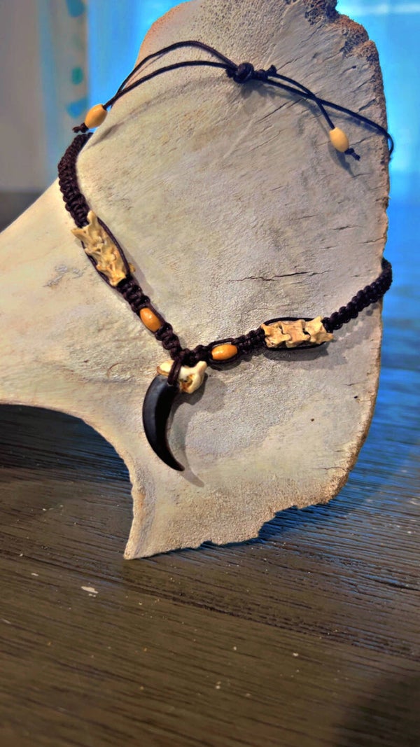 wolf claw necklace adorned with rattle snake vertebrae beads