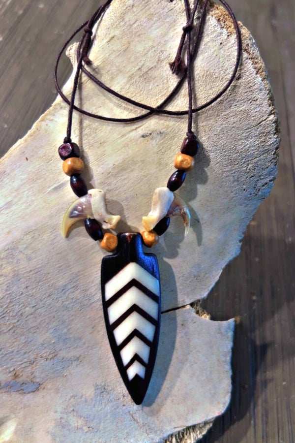 arrow head pendant adorned with bobcat claws necklace