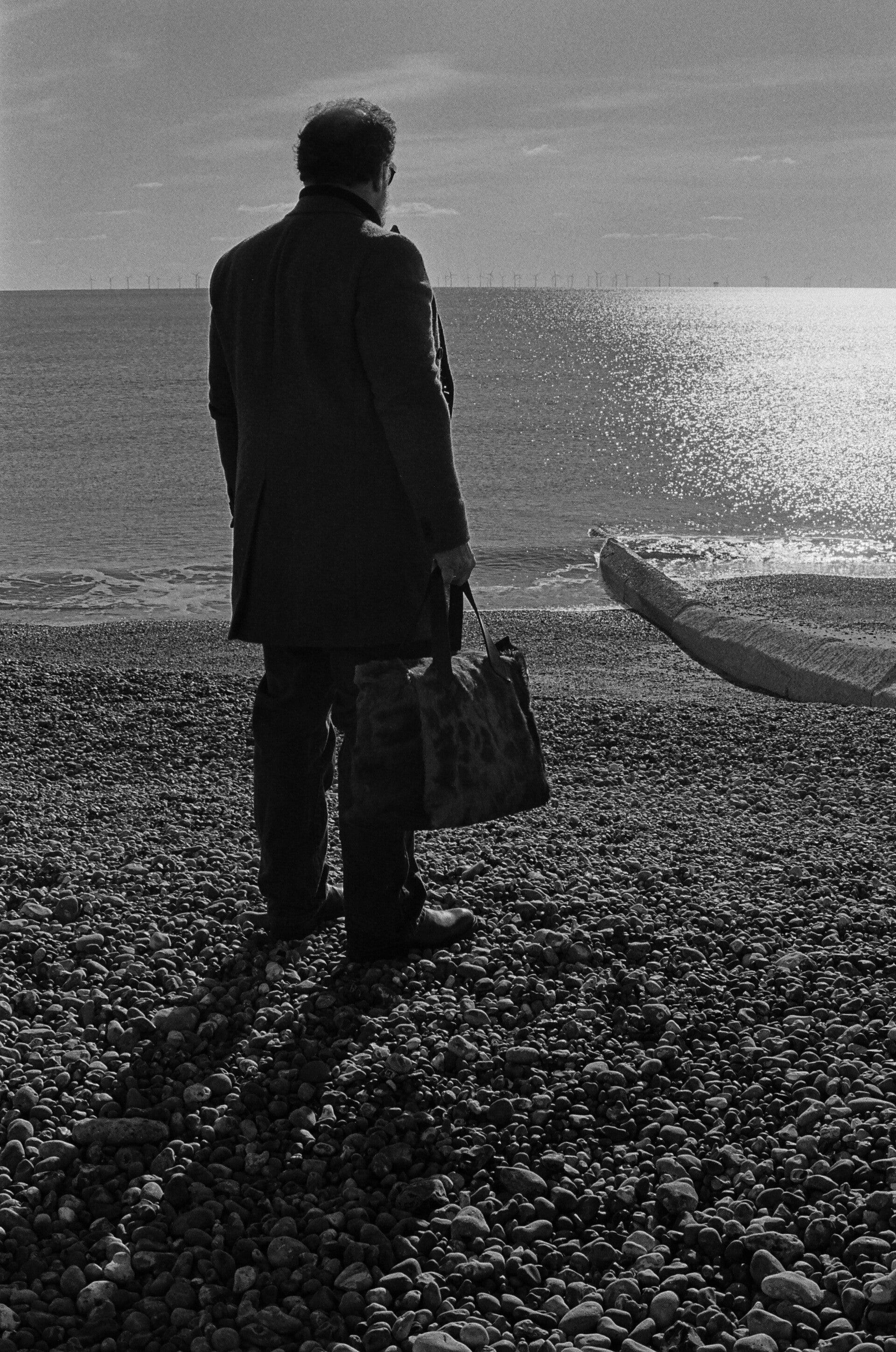 A gentleman with travelling bag on the beach
