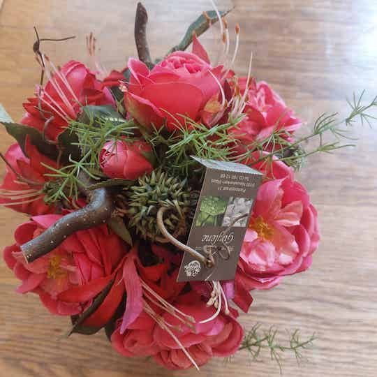 Bloemstuk met roze namaakbloemen