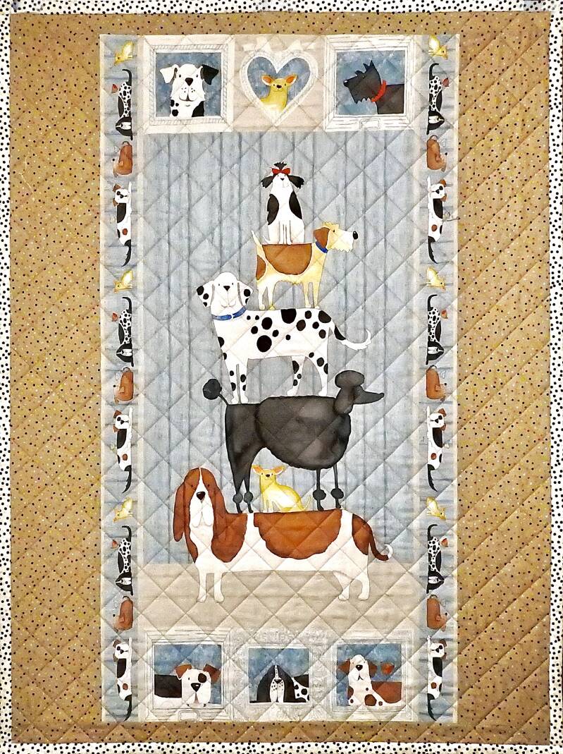 Kinderdekentje met akrobatische opstapeling van vrolijke hondjes.