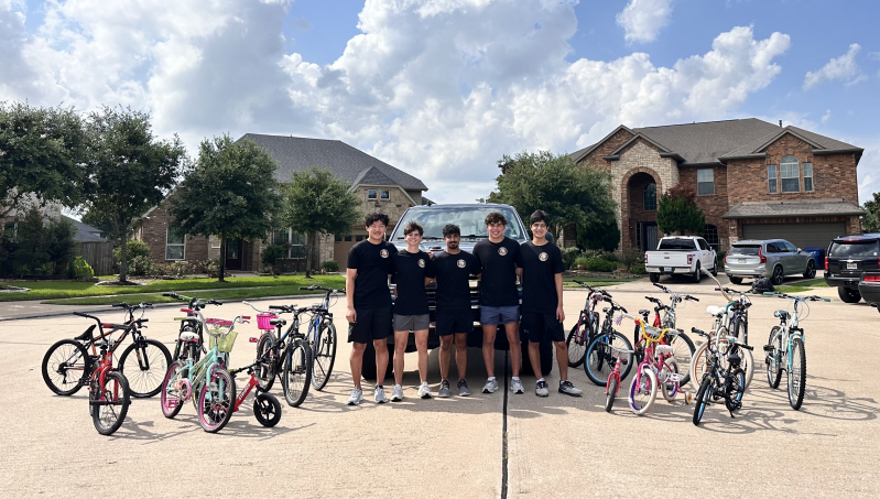 Penny Pedals Officer Team gathered with donated bikes and bikes to repair.