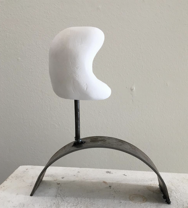 Carved plaster sculptures on metal stand