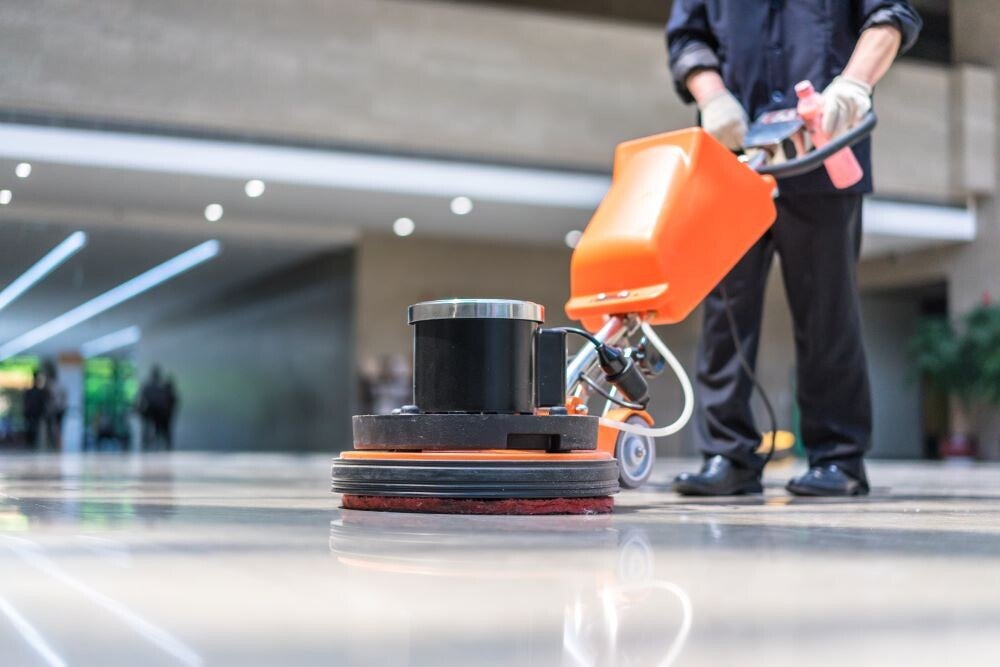 Professional floor polishing in a modern building, creating a spotless, high‑shine surface with commercial cleaning equipment.