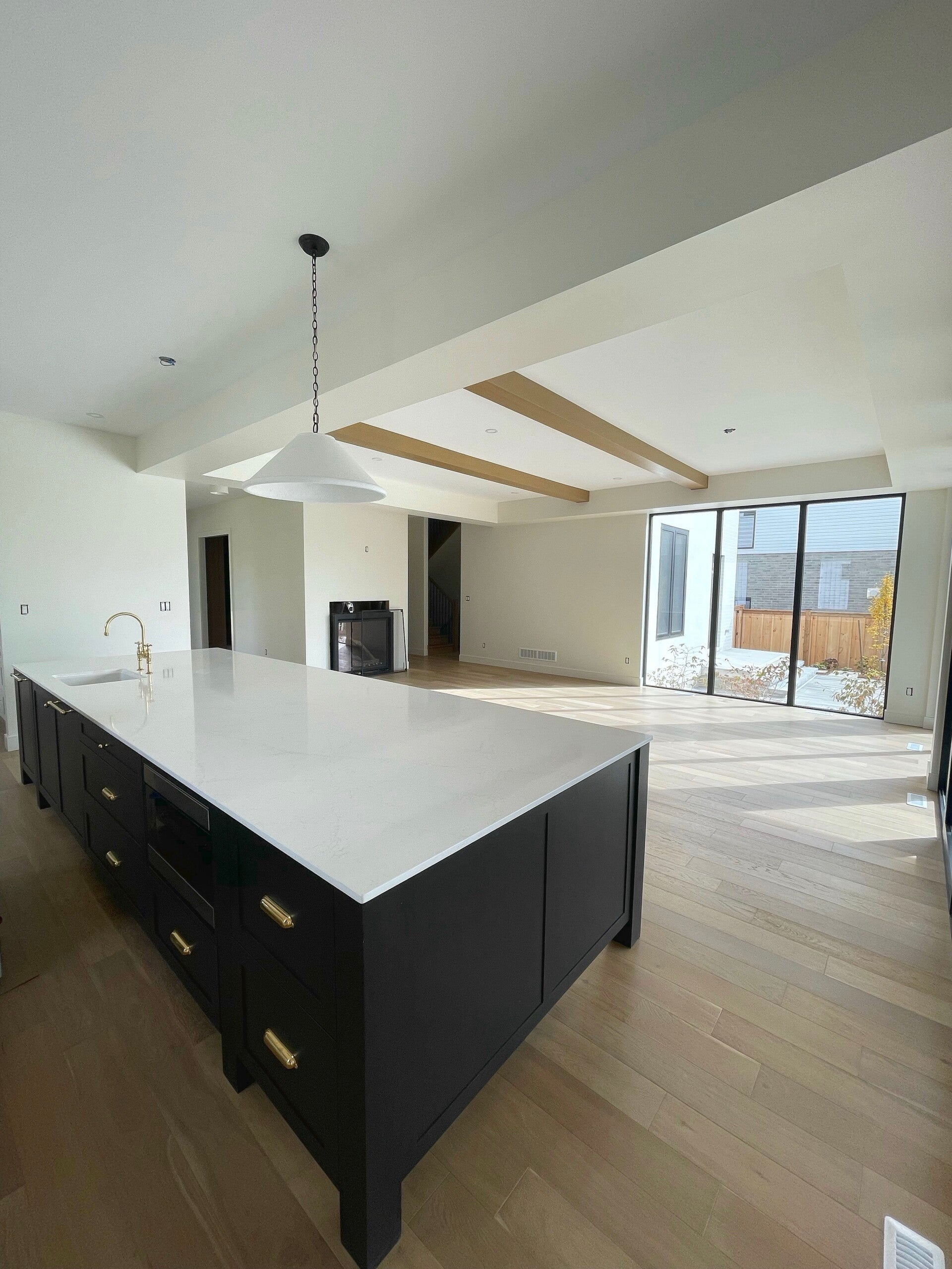 Spotless modern kitchen with polished surfaces, clean wood floors, and bright natural light showcasing professional home cleaning.