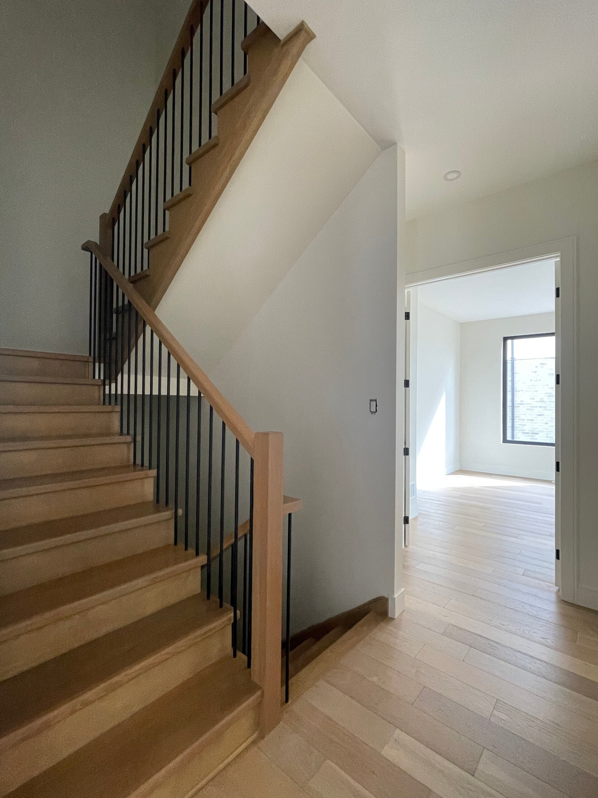 Spotless walk‑in closet with polished cabinetry and a clean staircase featuring bright wood steps, showcasing professional home cleaning quality.