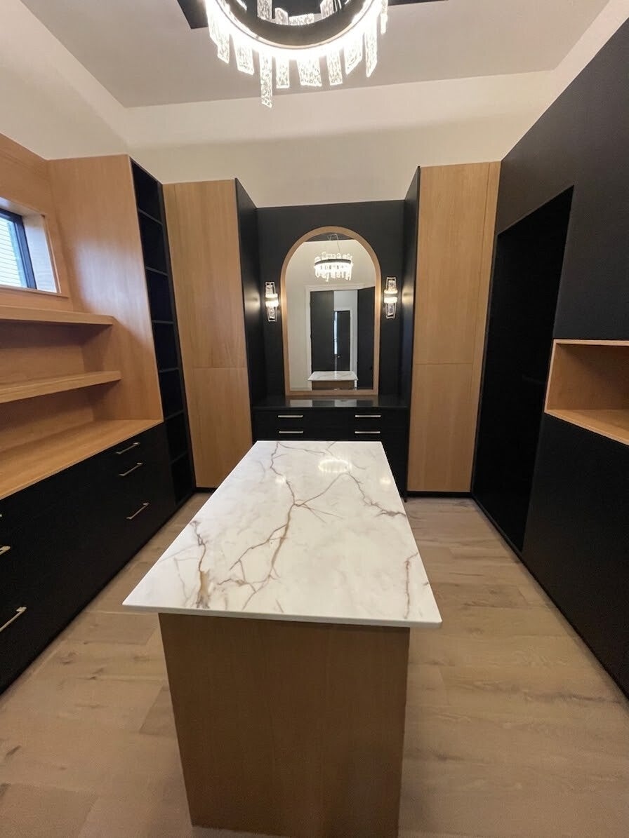 Spotless walk‑in closet with polished cabinetry and a clean staircase featuring bright wood steps, showcasing professional home cleaning quality.