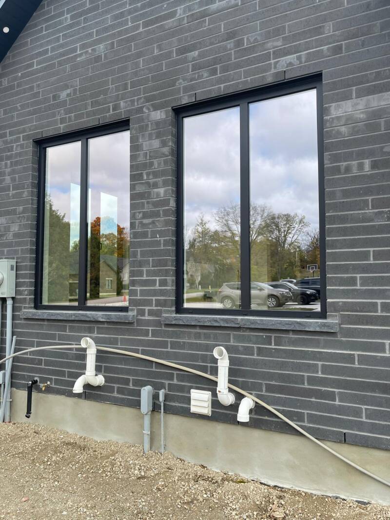 Modern residential windows with clear, streak‑free glass and clean black framing showcasing professional exterior window cleaning.