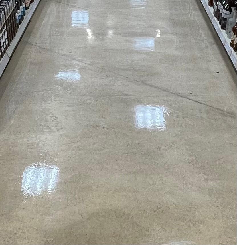 Polished commercial floors with a glossy, reflective finish showcasing professional deep‑cleaning and floor‑restoration quality.