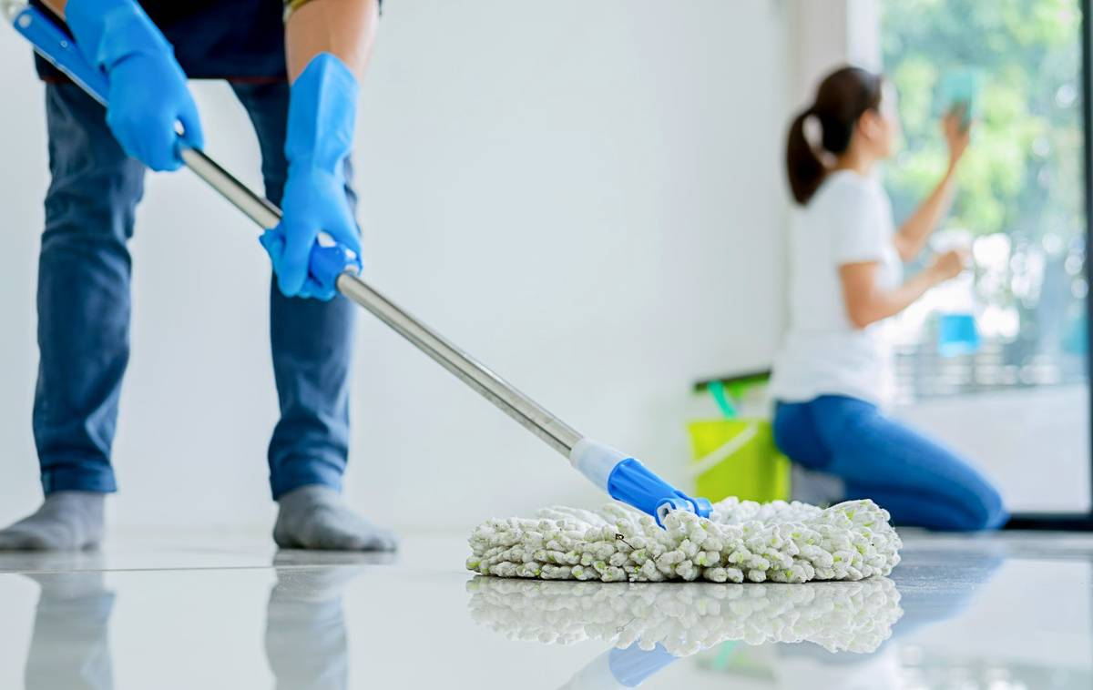 Team providing expert commercial cleaning with thorough floor mopping and window wiping for a spotless, hygienic result.