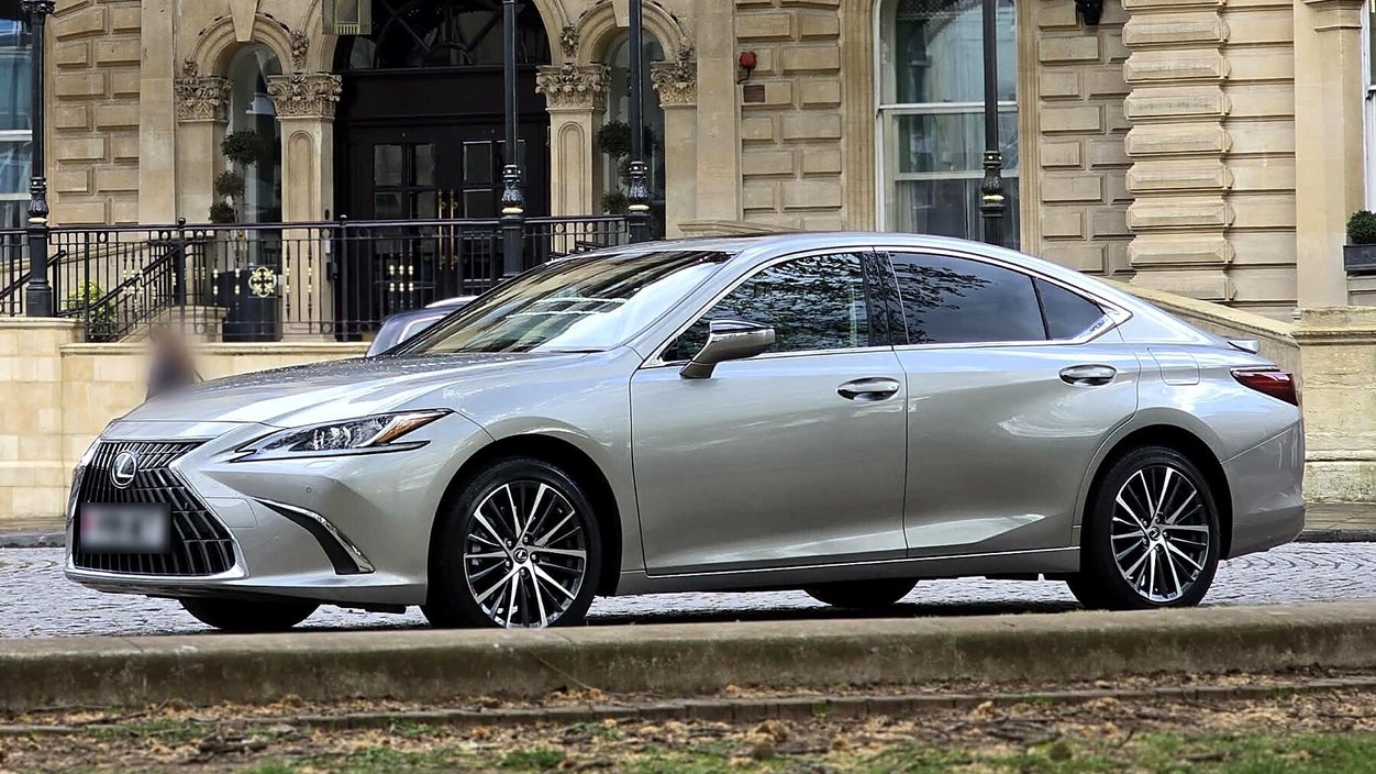 Silver Lexus ES 300h executive saloon waiting outside a period hotel entrance