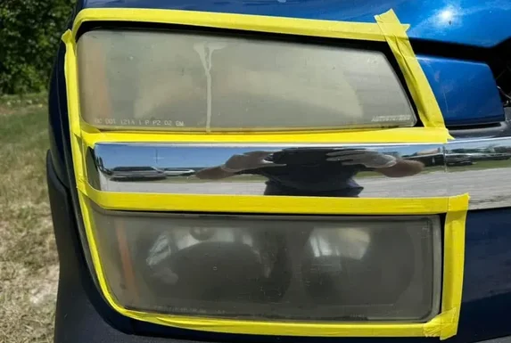 Before: Foggy, oxidized headlight lenses on blue Silverado