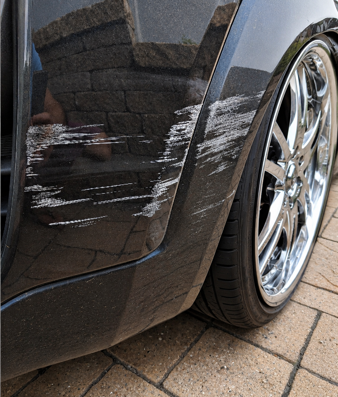 Scratches on rear bumper of charcoal cat