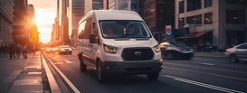 Shuttle Van driving through the downtown area of a city