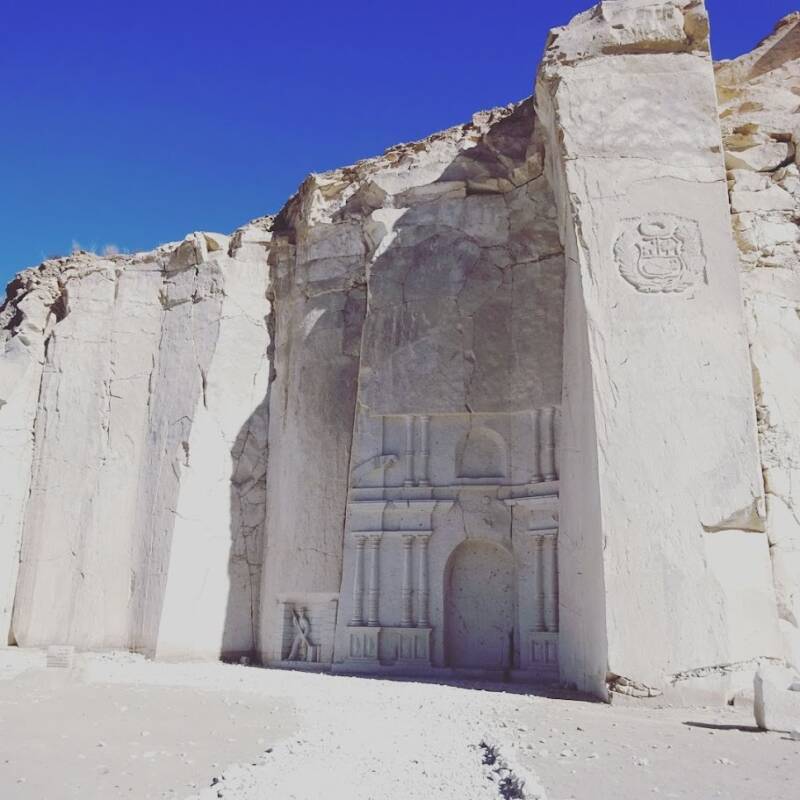 Uitgehakte kerkgevel in de witte sillarwand van de steengroeve van Añashuayco bij Arequipa in Peru.