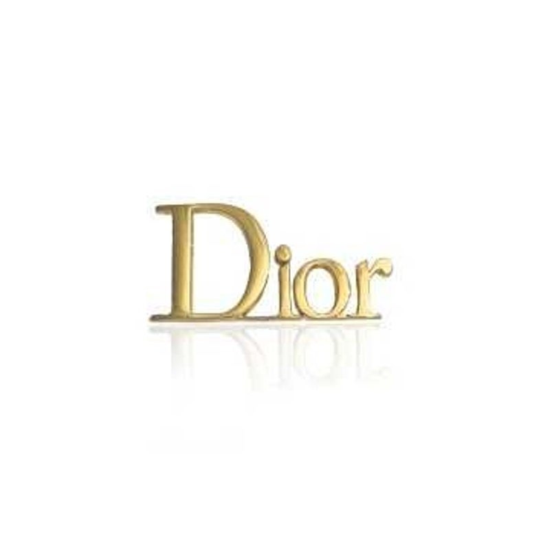 gouden-tandsieraad-dior.jpg