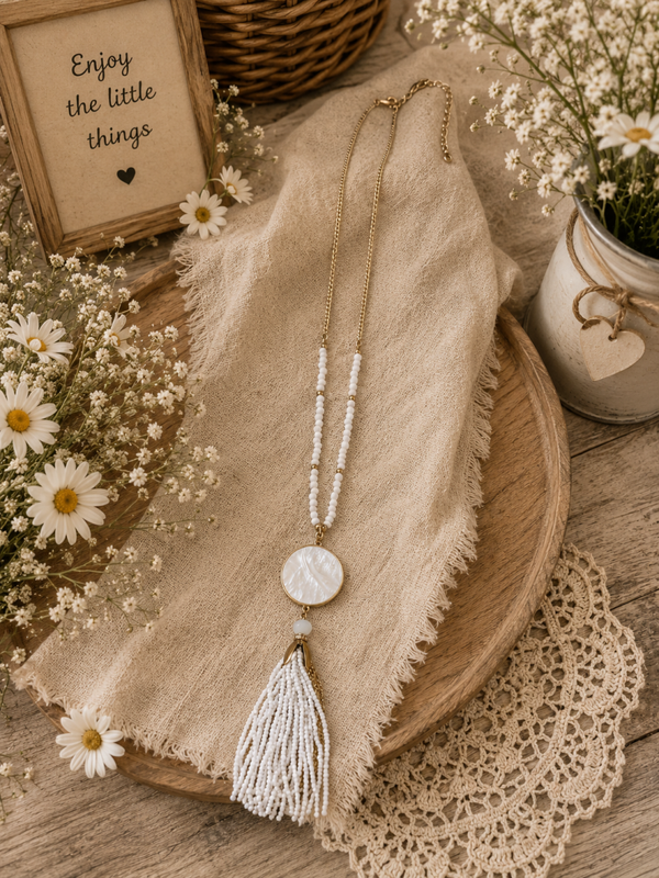 Long white beaded gold tone tassel necklace