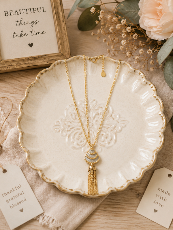 Necklace gold with crystals and tassel.