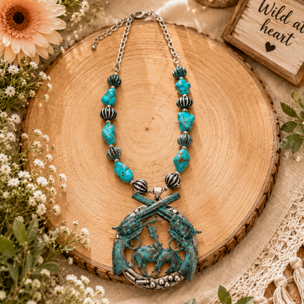 Patinaed crossed pistol & turquoise necklace