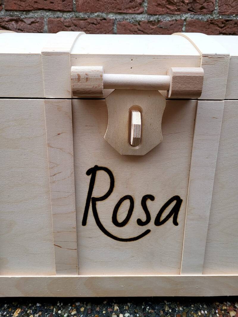 Speelgoed kist met de naam Rosa erop houtgebrand van dichtbij