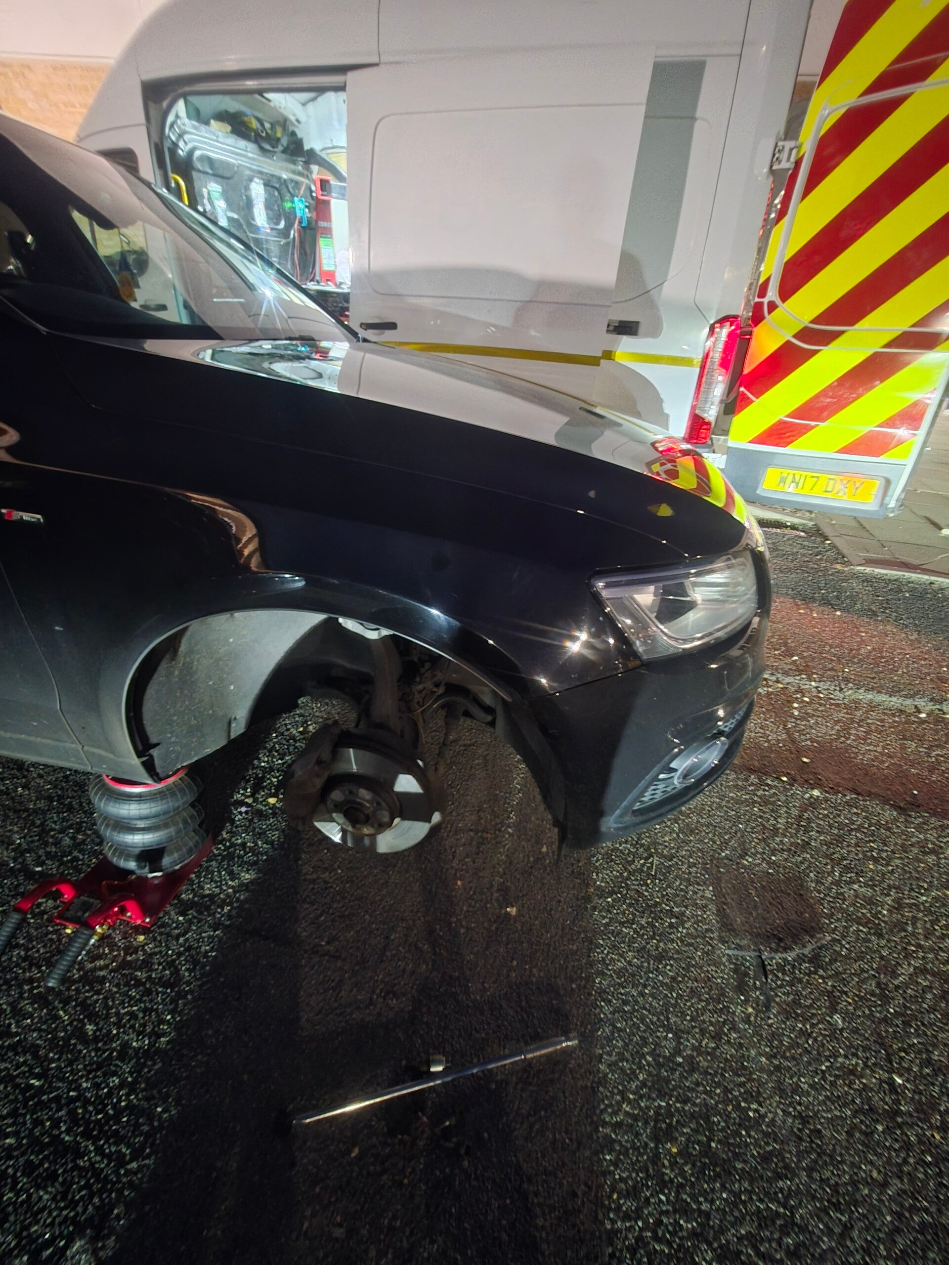 Brad’s Mobile Tyres technician fitting a car tyre roadside at night