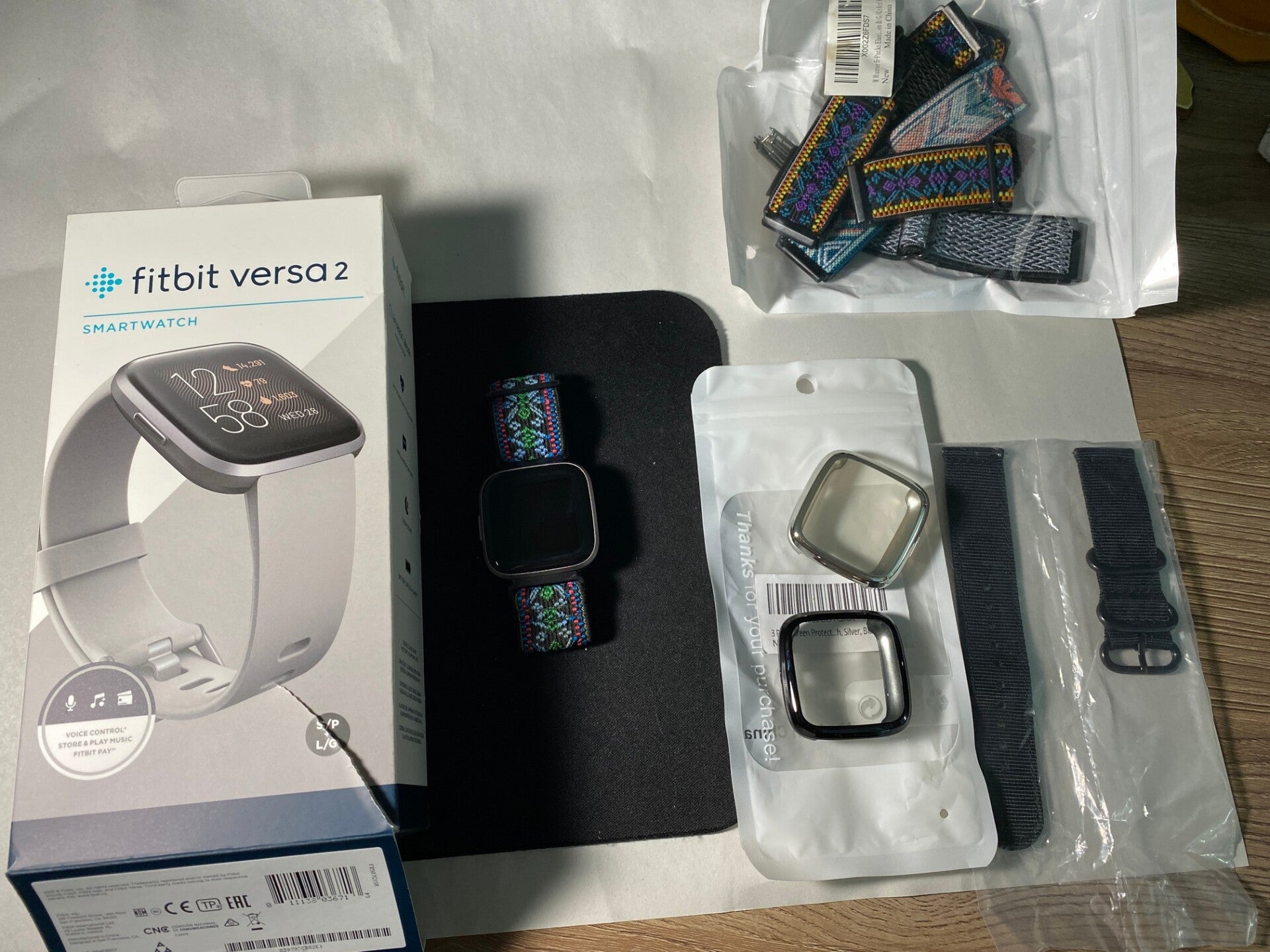 Fitbit Versa 2 smartwatch with additional bands and accessories