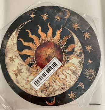 Decorative metal wall art featuring sun and moon celestial design