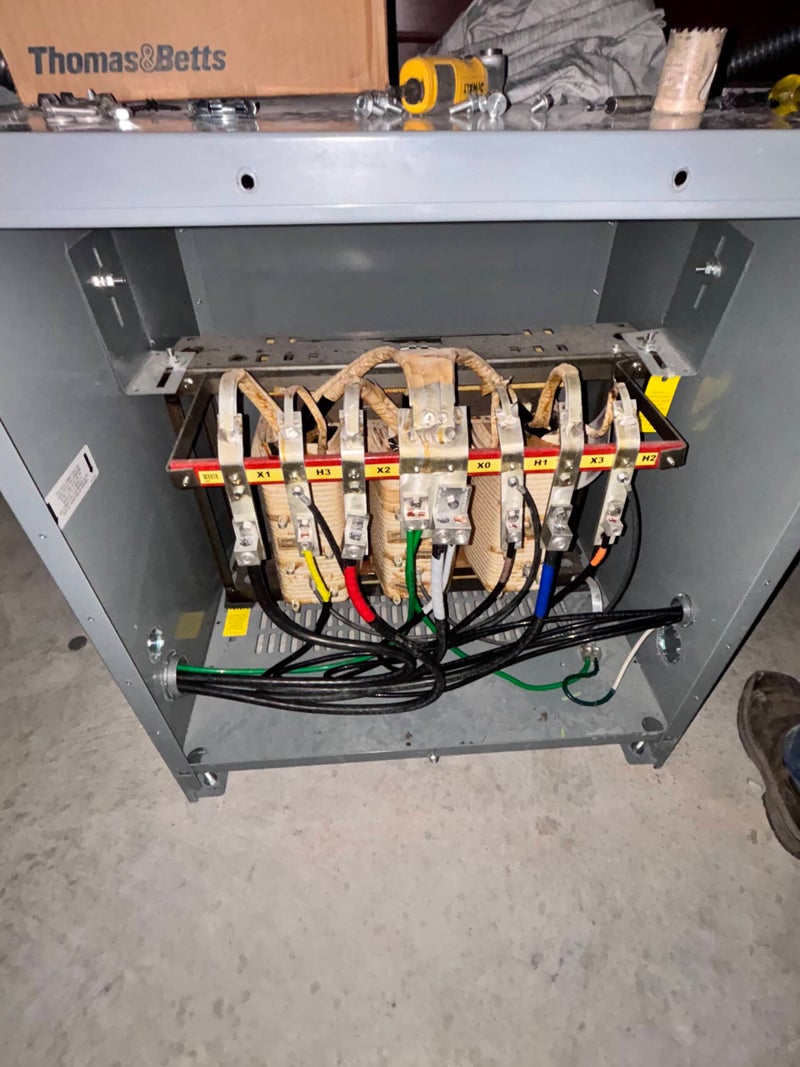 Commercial dry-type transformer with labeled primary and secondary terminals