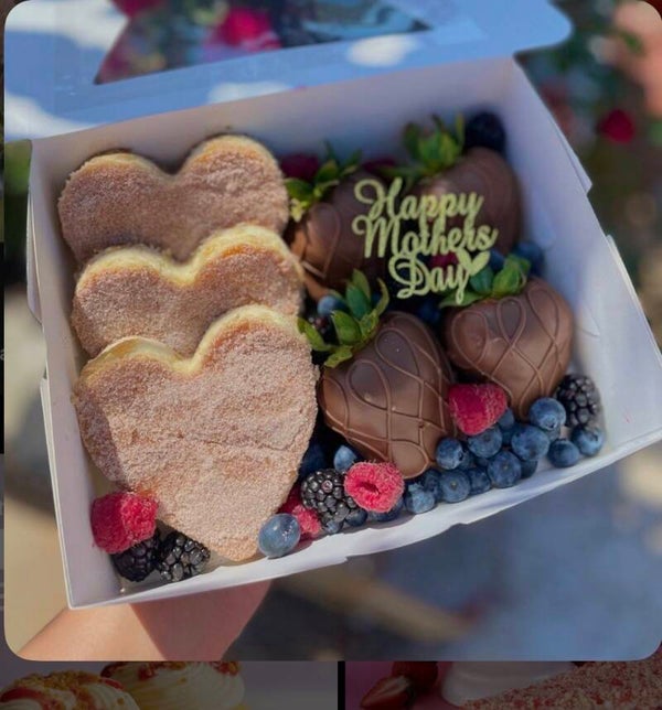 Mothers Day Churro cheesecake with chocolate covered strawberries
