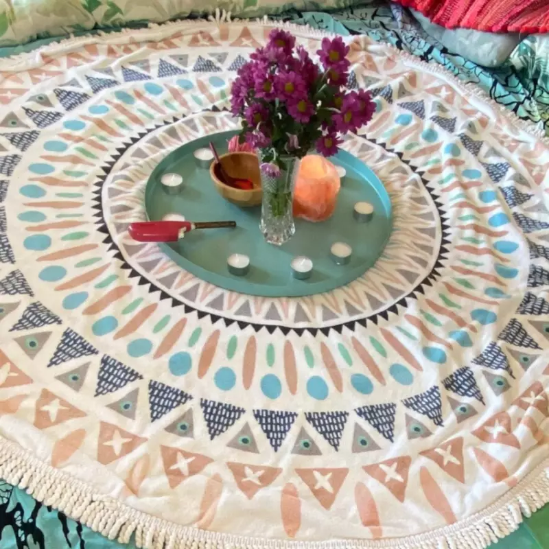 Mother blessing altar on mandala towel, flowers, candles, precious stione beats and rope