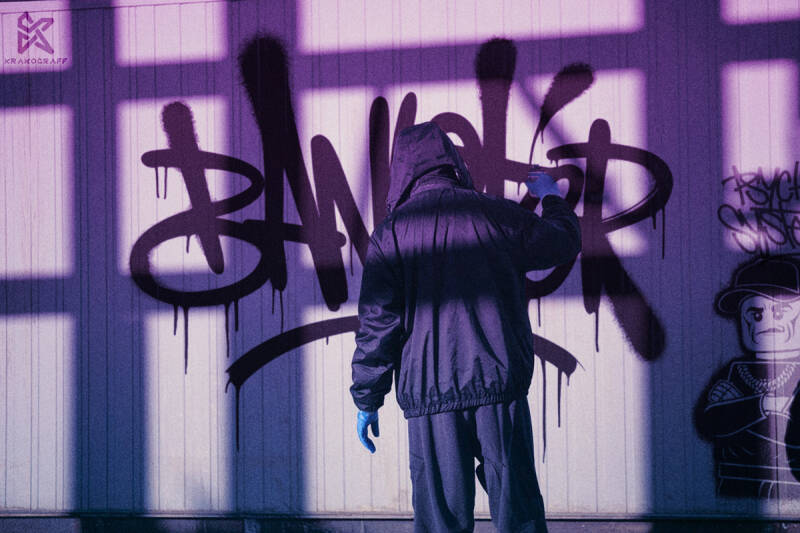 graffiti artist tagging on wall