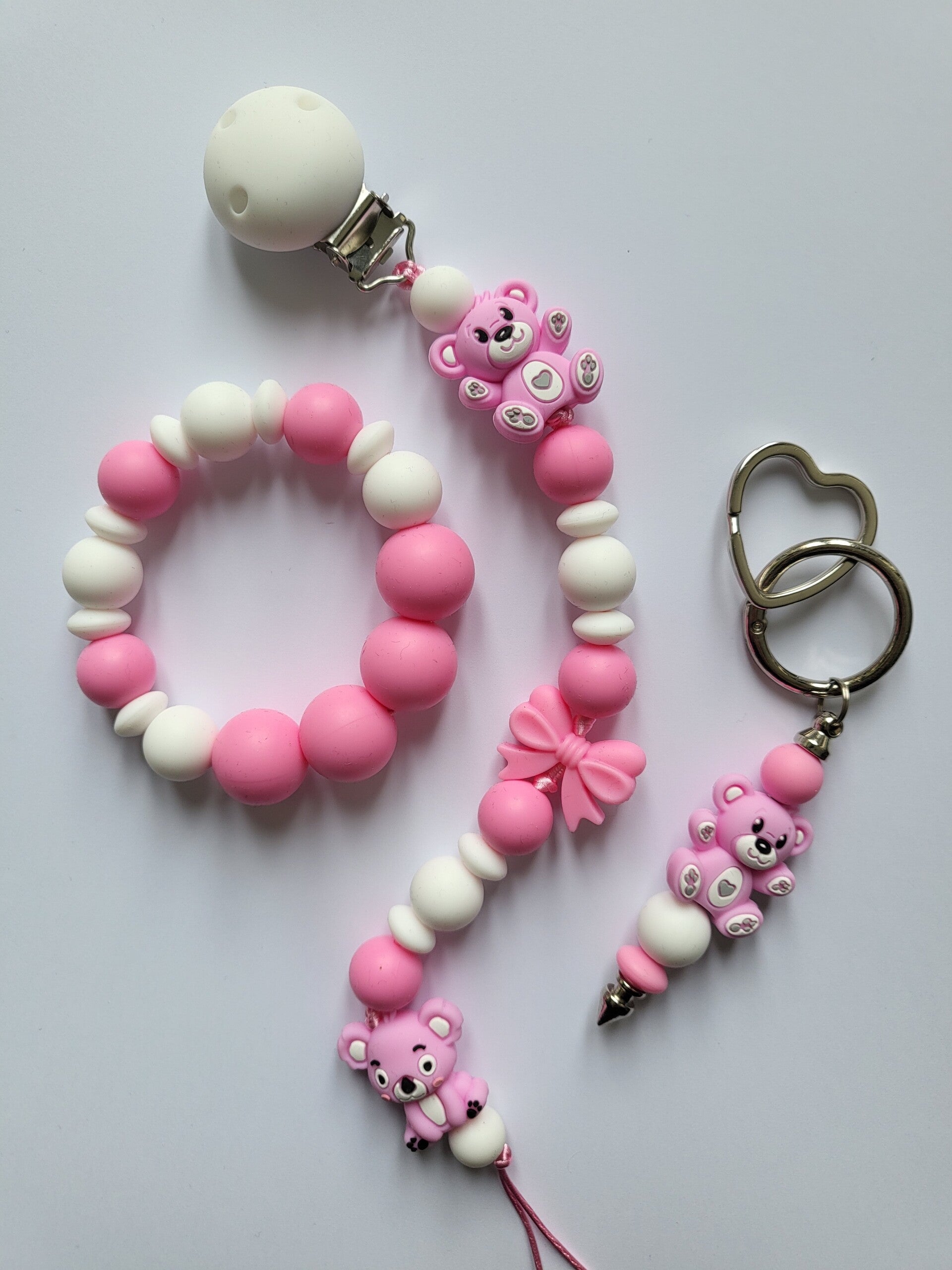 Speenkoord en bijtring met teddybeertje en koalabeertje in fuchsia-roze en wit.