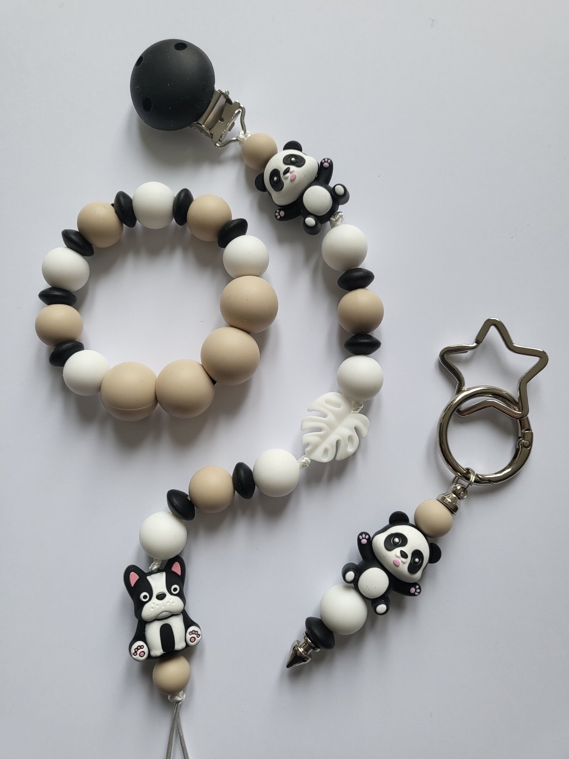 Speenkoord en bijtring met panda-beertje en hondje in zwart, wit en beige.