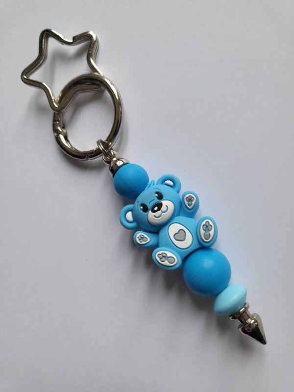Tashanger met teddybeertje in kobaltblauw, zee-blauw en wit.
