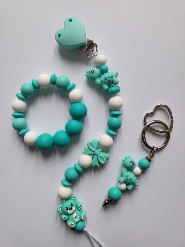 Speenkoord en bijtring met teddybeertje en dinosaurusje in mintgroen, turquoise en wit.