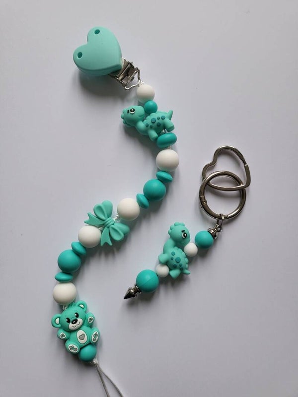 Speenkoord met teddybeertje en dinosaurusje in mintgroen, turquoise en wit.