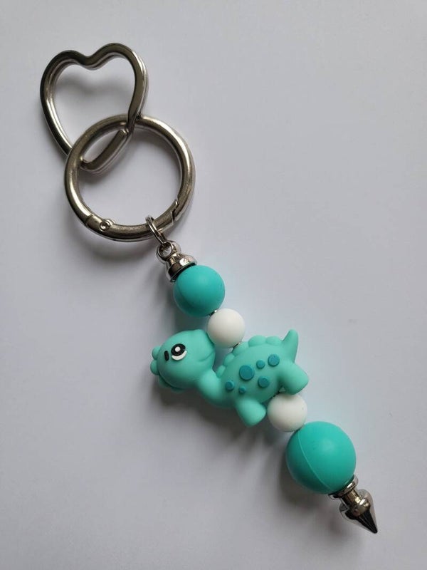 Tashanger met dino in mintgroen, turquoise en wit.
