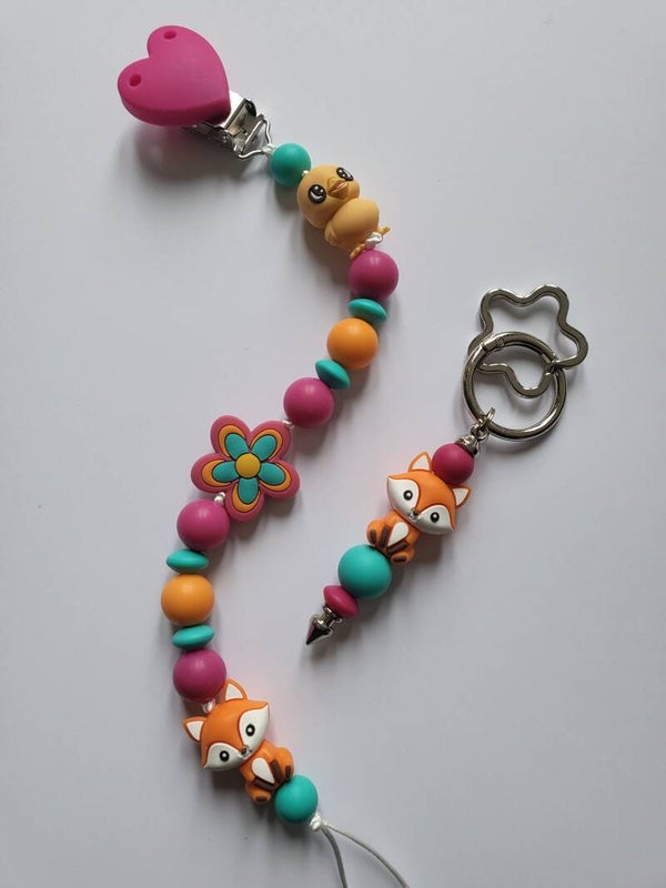 Speenkoord met kuikentje en vosje in fuchsia-roze, oranje en turquoise.