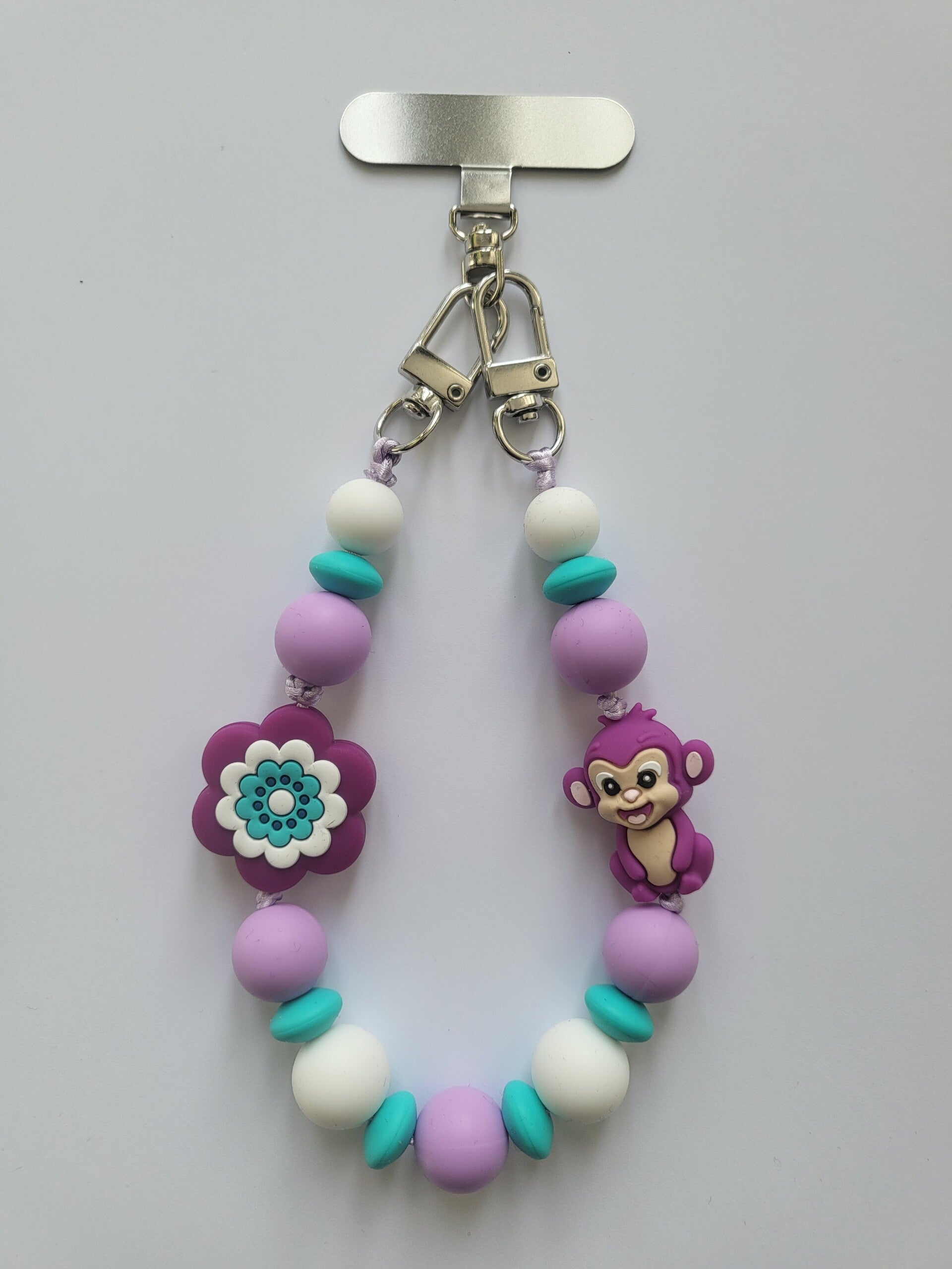 telefoonkoord met aapje in lila, turquoise en wit.