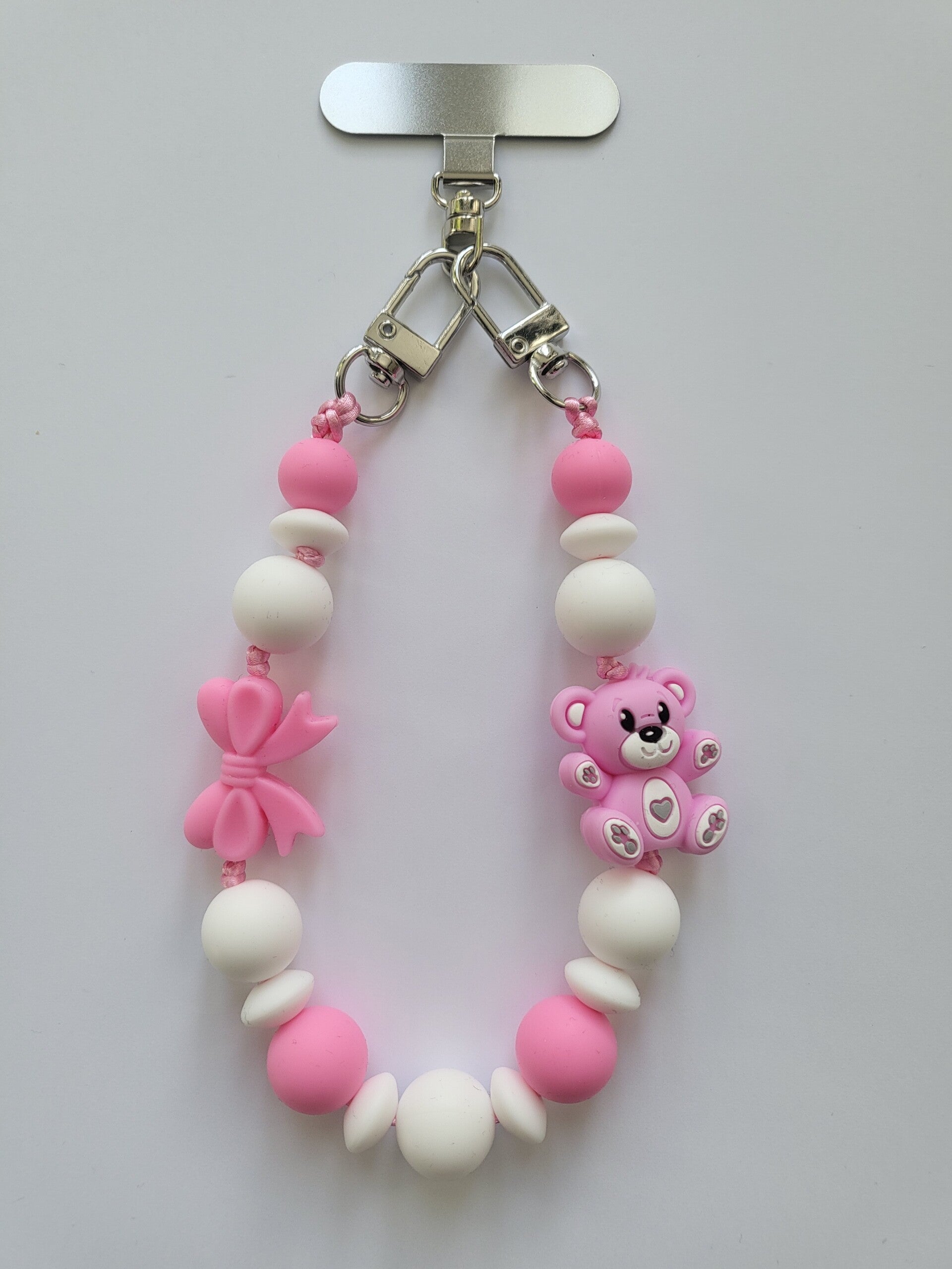 Telefoonkoord met teddybeertje in fuchsia-roze en wit.