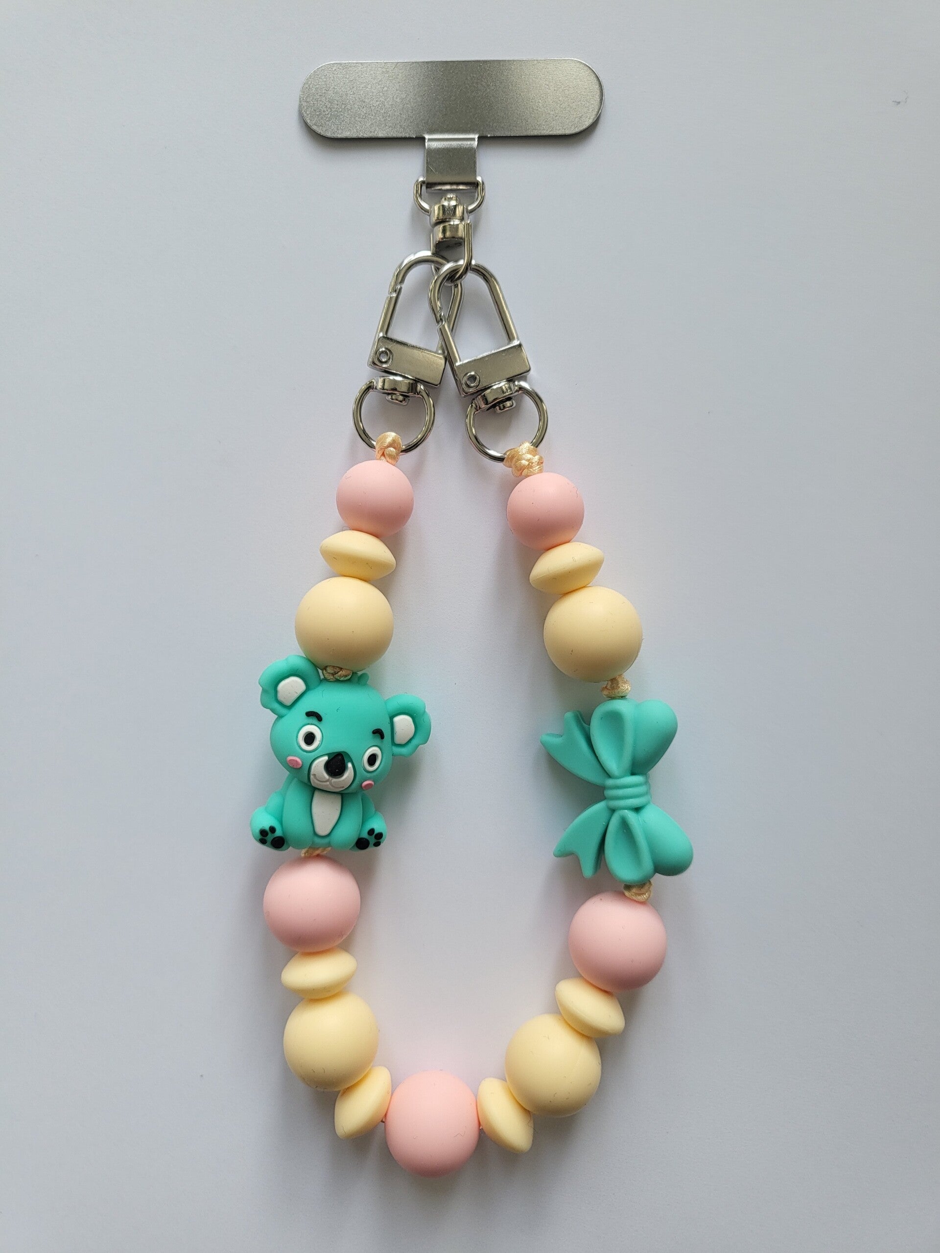 Telefoonkoord met koalabeertje in lichtroze, turquoise en lichtgeel.