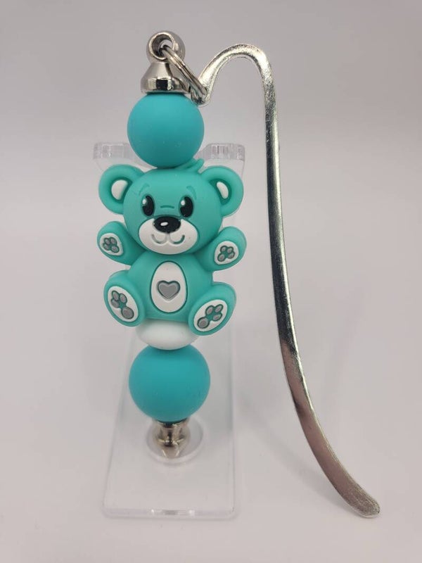 Boekenlegger met teddybeertje in mintgroen, turquoise en wit.