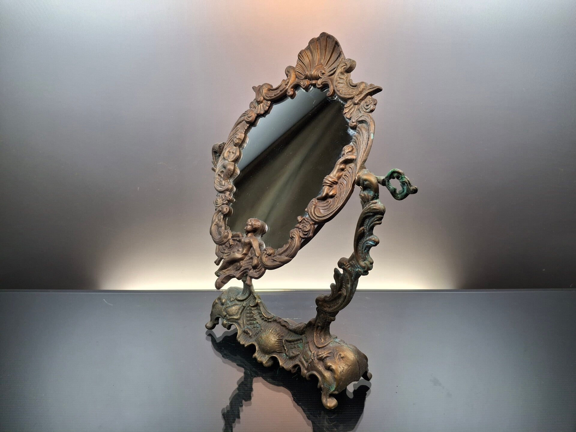 Antique Bronze table mirror with angel.