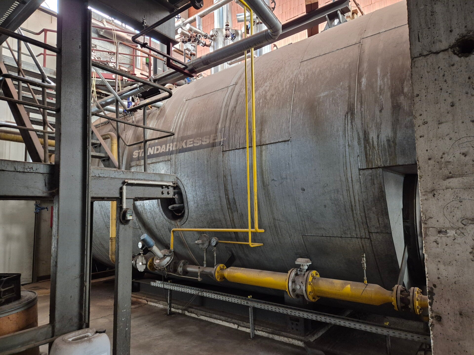 Side view of the original Standardkessel HD 0601-12 steam boiler and gas supply pipework
