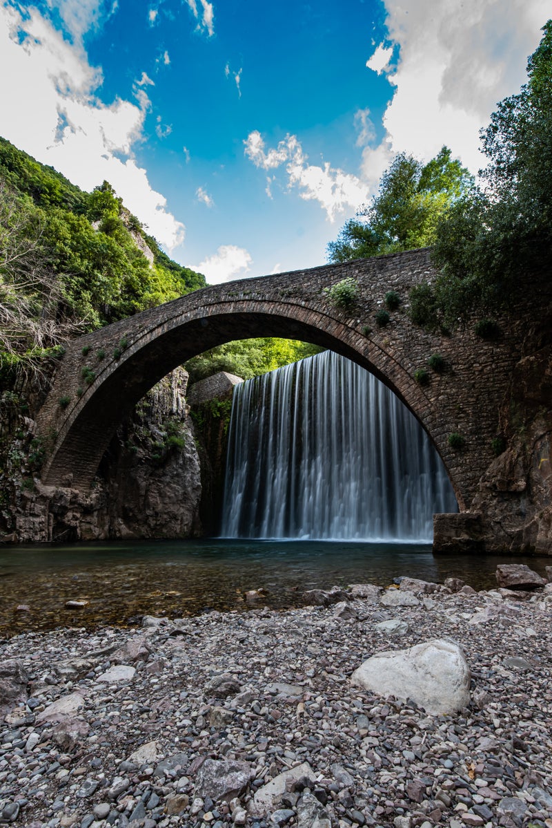 waterfall under a bridge