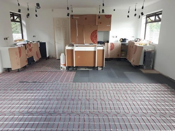 Kitchen fitting with underfloor heating and lighting during installation in Hertfordshire