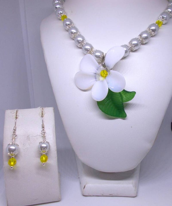 Glass flower with pearl and crystal necklace and earring set.