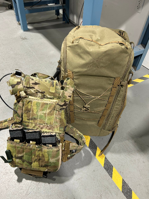 Multicam Renegade sewing JTAC plate carrier rigged to control a UAV pictured next to the backpack that contains the UAV in questions.