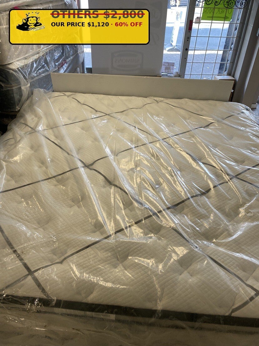 White tufted pillow-top mattress close-up at Mattress Monkey Liquidation, mattress store in Chilliwack BC
